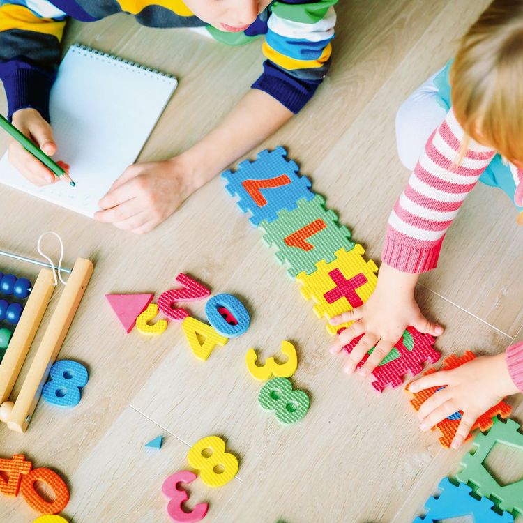 little boy and girl learn to write and calculate numbers